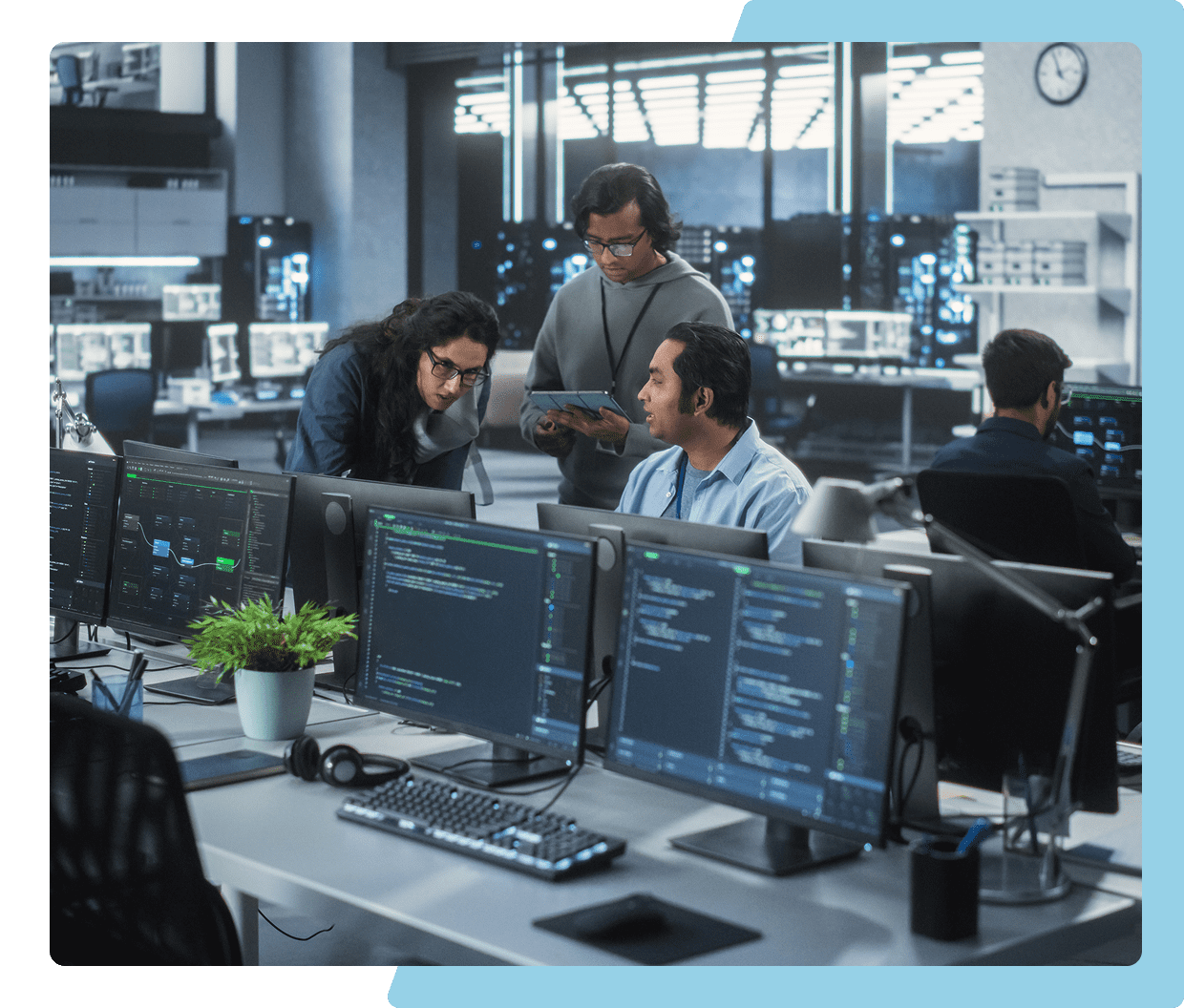 Office workers collaborating in a modern tech workspace.